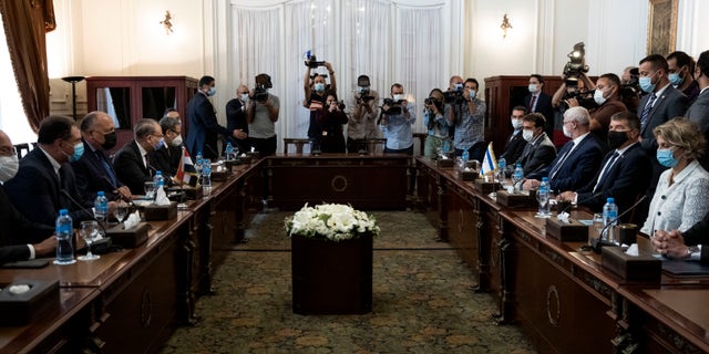 Egyptian Foreign Minister Sameh Shoukry, third from left, meets with Israeli Foreign Minister Gabi Ashkenazi, second  from wldright, at the Tahrir Palace in Cairo, Egypt, Sunday, May 30, 2021. (AP Photo/Nariman El-Mofty)