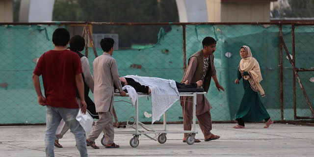 An injured school student is transported to a hospital after a bomb explosion near a school in west of Kabul, Afghanistan, Saturday, May 8, 2021. (Associated Press)