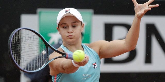 Australia's Ashleigh Barty returns the ball to United States' Cori Gauff during their quarter-final match at the Italian Open tennis tournament, in Rome, Friday, May 14, 2021. (AP Photo/Gregorio Borgia)