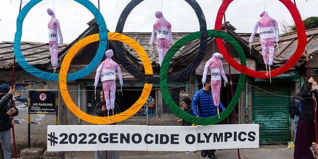 Exiled Tibetans use the Olympic rings as a prop when holding a street protest against the event of the Beijing 2022 Winter Olympics in Dharmsala, India, on February 3, 2021.