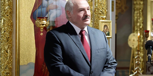 Belarusian President Alexander Lukashenko, left, attends the Orthodox Easter service in the town of Turov, some 270 km (167 miles) south of Minsk, Belarus, Sunday, May 2, 2021. (Maxim Guchek/BelTA Pool Photo via AP)