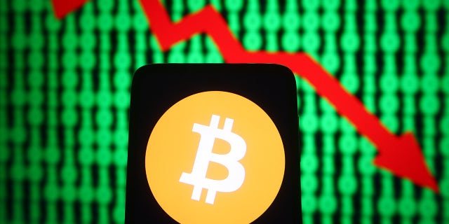 Bitcoin (BTC) cryptocurrency is seen going down. (Photo Illustration by Pavlo Gonchar/SOPA Images/LightRocket via Getty Images)