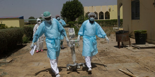 April 30, 2021: Doctors caring with COVID-19 patients ferry medical equipment, at the Farcha provincial hospital in N'Djamena, Chad.