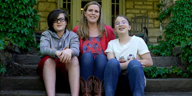 May 4, 2021: Heather Ousley, who plans to get her kids vaccinated as soon as they are eligible, sits with her older children Elliannah, 15, right, and Samuel, 13, in front of their home in Merriam, Kan.