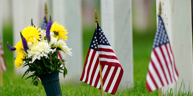 Flags and tributes mark the Memorial Day holiday are placed among the headstones in Fort Logan National Cemetery Monday, May 31, 2021, in southeast Denver. More than 105,000 graves were decorated with flags to mark the holiday.