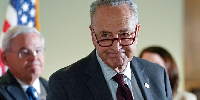 Senate Majority Leader Chuck Schumer of N.Y., walks away following a media availability on Capitol Hill in Washington, Tuesday, May 18, 2021. Sen. Bob Menendez, D-N.J., is at left. (AP Photo/Susan Walsh)