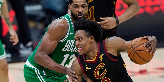 Cleveland Cavaliers' Collin Sexton (2) drives against Boston Celtics' Tristan Thompson (13) during the second half of an NBA basketball game Wednesday, May 12, 2021, in Cleveland. (AP Photo/Tony Dejak)
