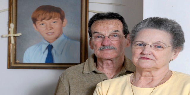 Carl and Bunny Croteau stand in front of a portrait of their murdered son, Danny, in their Springfield, Massachusetts home in this Feb. 26, 2008 file photo. (AP)