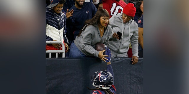 DeAndre Hopkins of the Houston Texans hands the ball to his mother Sabrina Greenlee after a touchdown in the second quarter over the Indianapolis Colts at NRG Stadium on November 21, 2019, in Houston, Texas. 