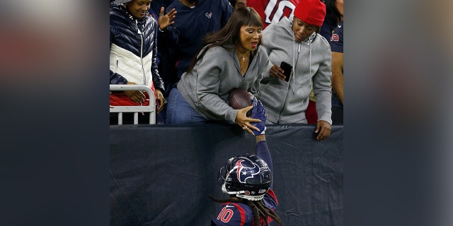 DeAndre Hopkins of the Houston Texans hands the ball to his mother Sabrina Greenlee after a touchdown in the second quarter over the Indianapolis Colts at NRG Stadium on November 21, 2019, in Houston, Texas.