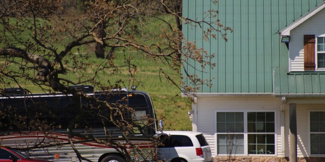 Two cars and an oversized bus were in the driveway of the home on April 30.