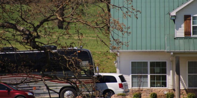 Two cars and an oversized bus were in the driveway of the home on April 30.