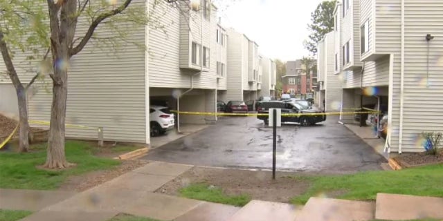 Police tape blocks entry into an apartment complex where Englewood police officers were struck by a motorist.