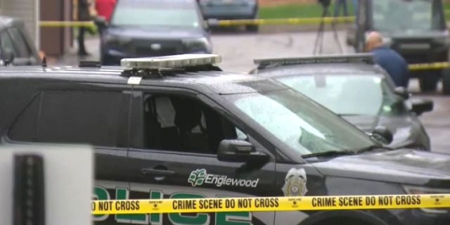 Police in Englewood, 可乐, respond to the scene where a motorist was fatally shot after allegedly striking three officers with his car.