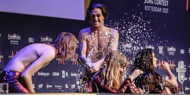 Damiano David, centre, sprays champagne onto Thomas Raggi, from left, Victoria De Angelisa and Ethan Torchio at the press conference after their band Maneskin from Italy won the Grand Final of the Eurovision Song Contest at Ahoy arena in Rotterdam, Netherlands, Saturday, May 22, 2021.