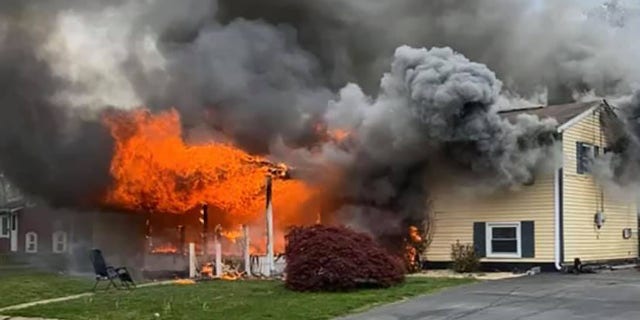 Witnesses said that a woman set her house on fire before sitting in a lawn chair, pictured above, to watch.