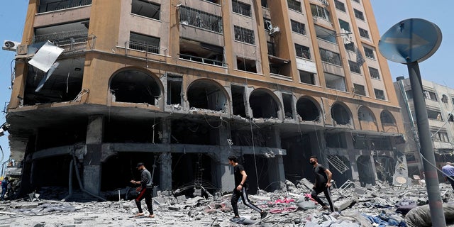 People inspect the rubble of a damaged building which was hit by an Israeli airstrike in Gaza City on Wednesday. (AP)