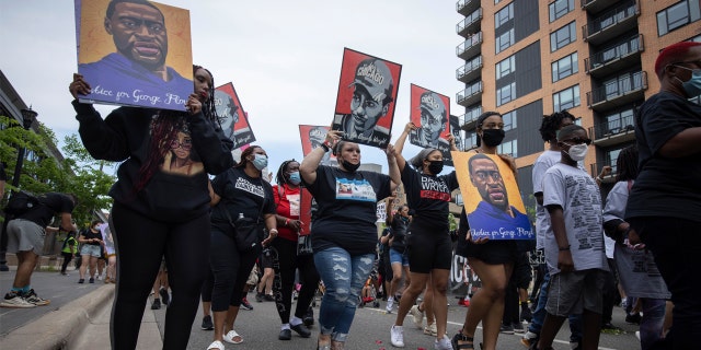 Dante Wright's family marched on Sunday, May 23, 2021, in Minneapolis, Minn., To mark the one-year anniversary of George Floyd's death.