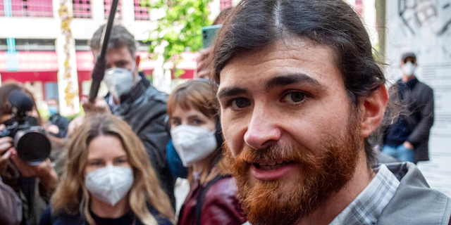 The defendant identified only as 1st Lt. Franco A. due to German confidentiality rules, heads to court for the start of a trial for preparation of a serious act of violence endangering the state in Frankfurt, in Germany, Thursday, May 20, 2021..