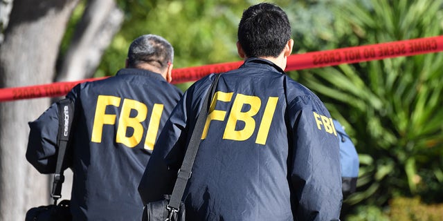 FBI agents approach a crime scene