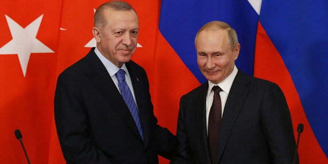 Russian President Vladimir Putin and Turkish President Recep Tayyip Erdogan shake hands during their talks at the Kremlin March 5, 2020, in Moscow.