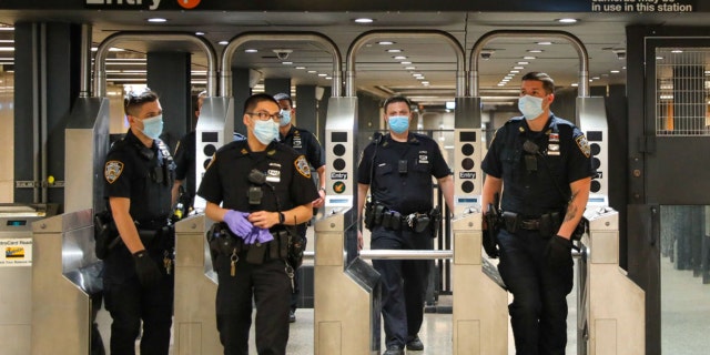 NEW YORK, NY - MAY 15: Police officers on patrol around Times Square subway station on May 15, 2020 in New York City. (Photo by Jose Perez/Bauer-Griffin/GC Images)