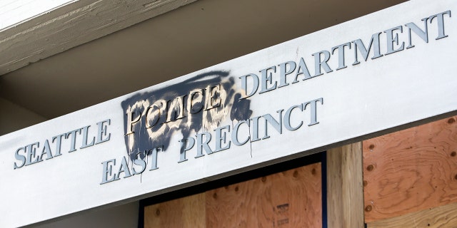 The word "people" is spray-painted over the word "police" on the closed Seattle Police Department's East Precinct now surrounded by the area known as the Capitol Hill Autonomous Zone (CHAZ), in Seattle, Washington, on June 11, 2020.