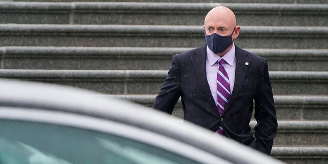 Sen. Mark Kelly, D-Ariz., walks to his car on February 13, 2021 in Washington, D.C. Kelly has been reluctant to endorse a specific plan on changing the Senate filibuster, but said he is open to it. (Photo by Joshua Roberts/Getty Images)