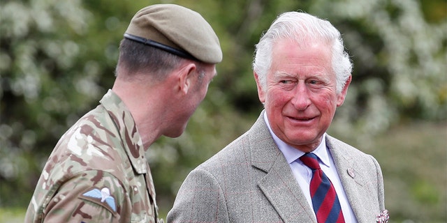 Prince Charles, Prince of Wales walks with Commanding Officer, Lieutenant Colonel Henry Llewelyn-Usher to the Officers' Mess as he arrives to visit members of the Welsh Guards at Combermere Barracks on May 5, 2021, in Windsor, England. 