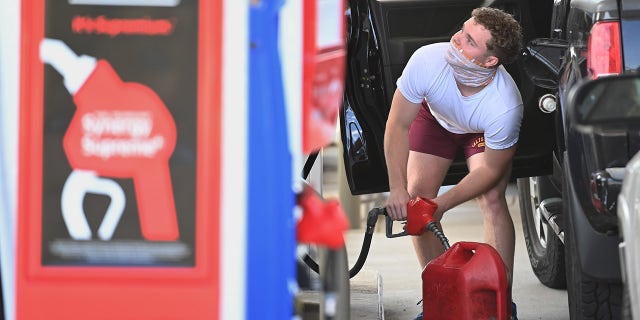 A man fills up a gas container after filling up his vehicle at an Exxon gas station on Wednesday May 12, 2021, in Springfield, VA. 