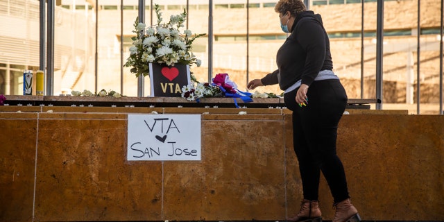 HERO Tent President Kiana Simmons places a candle at a vigil organized by her group following the mass shooting at the Valley Transportation Authority (VTA) light-rail yard, outside City Hall on May 26, 2021, in San Jose, California. (Getty Images)