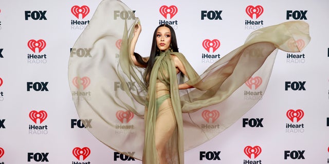 Doja Cat hits dons a sheer gown by Brandon Maxwell at the 2021 iHeartRadio Music Awards. (Photo by Emma McIntyre/Getty Images for iHeartMedia)