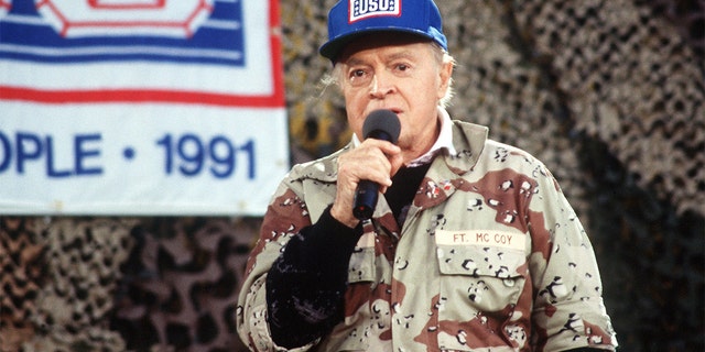 Entertainer Bob Hope performs for military personnel at the USO Christmas Tour, Operation Desert Shield, during the Gulf War in 1990 in Saudi Arabia.