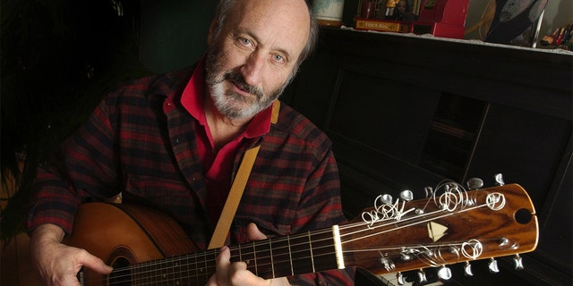 Noel Paul Stookey shows off a 12 string guitar custom-made by a Maine artisan, circa 2003. Stookey spends much of his time at his home in Blue Hill, Maine.