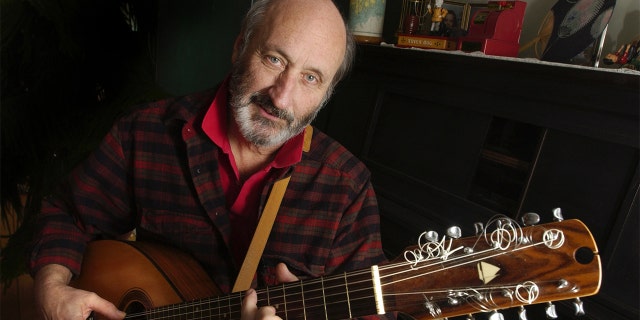 Noel Paul Stookey shows off a 12 string guitar custom-made by a Maine artisan, circa 2003. Stookey spends much of his time at his home in Blue Hill, Maine.