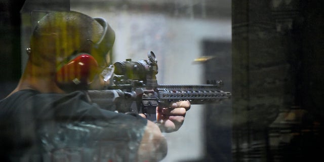Weapons enthusiast Josue Perez launches an AR15 rifle at the LAX shooting range in Inglewood, California on September 7, 2016. / AFP / Frederic J. BROWN / TO GO WITH AFP HISTORY OF VERONIQUE DUPONT-"Armed Democrats are fighting at the firearms border in California"        (Photo credit should be read FREDERIC J. BROWN / AFP via Getty Images)