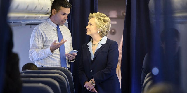 Hillary Clinton talks with her campaign's national press secretary, Brian Fallon, on her plane at Westchester County Airport on Oct. 3, 2016, in White Plains, New York.
