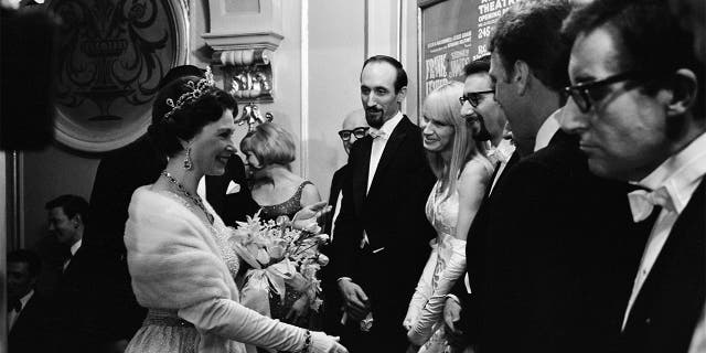 Royal Variety Performance, London Palladium, 8th November 1965. Queen Elizabeth II makes her way down the presentation line. Meeting folk singers Peter, Paul and Mary, and actor-comedian Peter Sellers.