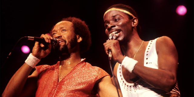 Maurice White and Philip Bailey performing on stage together.