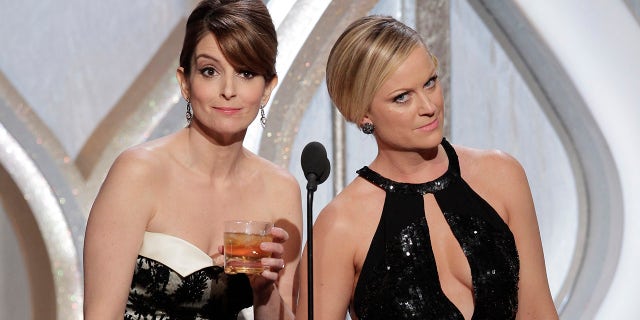 In this handout photo provided by NBCUniversal, (L-R) Tina Fey and Amy Poehler host the 70th Annual Golden Globe Awards at the Beverly Hilton Hotel International Ballroom on January 13, 2013 in Beverly Hills, California.
