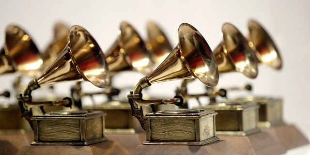 In this Oct. 10, 2017, file photo, various Grammy Awards are displayed at the Grammy Museum Experience at Prudential Center in Newark, N.J. The academy announced Wednesday that any producer, songwriter, engineer or featured artist on an album nominated for album of the year will also earn a nomination — even if the music creator co-wrote one song on the 10-track project.