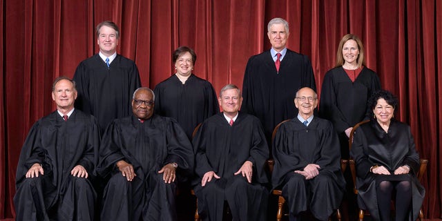 A photo of the nine sitting Supreme Court justices on April 23, 2021. Seated from left, Justices Samuel A. Alito, Jr. and Clarence Thomas, Chief Justice John G. Roberts Jr., and Justices Stephen G. Breyer and Sonia Sotomayor. Standing from left, Justices Brett M. Kavanaugh, Elena Kagan, Neil M. Gorsuch and Amy Coney Barrett.