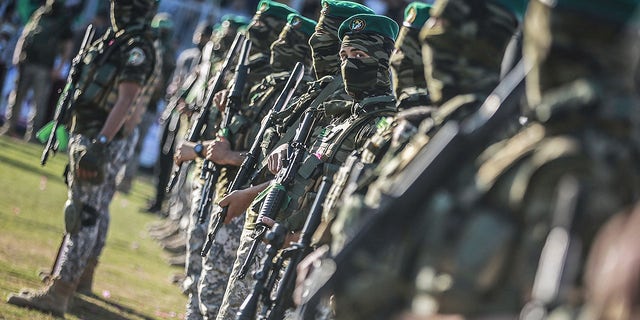 Members of Izz ad-Din al-Qassam Brigades, the military wing of the Palestinian Hamas Islamist movement in the Gaza Strip, take part in a rally to commemorate the martyrs of the last battle between Hamas and Israel May 24, 2021.