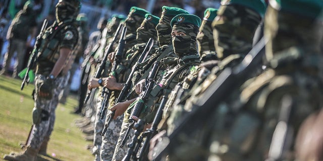 Members of the Izz ad-Din al-Qassam Brigades, the military wing of the Palestinian Islamist movement Hamas in the Gaza Strip, attend a rally to commemorate the martyrs of the latest battle between Hamas and Israel on May 24, 2021.