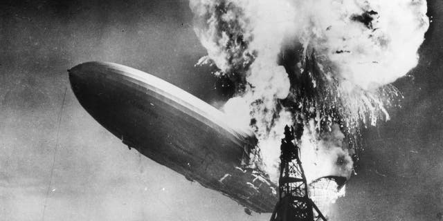 The Hindenburg (LZ-129) disaster at Lakehurst, New Jersey, which marked the end of the era of passenger-carrying airships. The image of the crash of the Nazi-era German aircraft played prominently in the branding of Led Zeppelin, appearing on the cover of its first two albums.