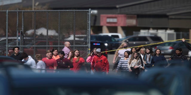 Students walk past police tape after the shooting at Rigby Middle School. They were reunited with their parents at a high school nearby. (AP/The Idaho Post-Register)