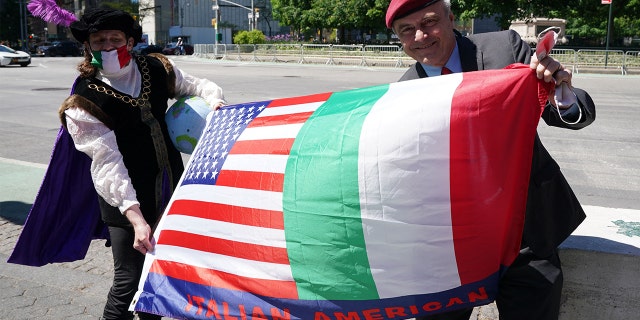 A man dressed as Christopher Columbus and mayoral candidate Curtis Sliwa hold a flag, as Italian American community groups hold a demonstration in Columbus Circle in New York on May 12, 2021 in support of Italian Heritage and Columbus Day.
