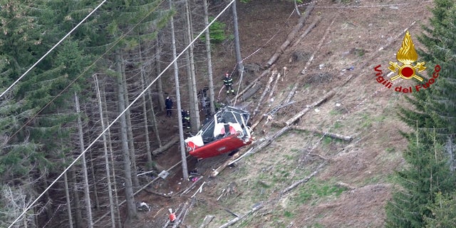 Rescuers work by the wreckage of the cable car. (AP/Vigili del Fuoco Firefighters)