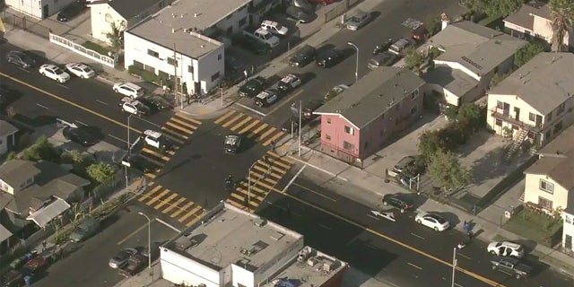 Aerial images above the scene show multiple police vehicles present at the San Francisco intersection where a double stabbing took place.