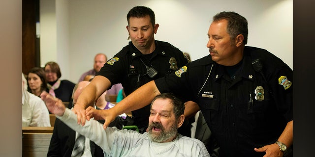 FILE - In this Nov. 10, 2015, file photo, Frazier Glenn Miller Jr., convicted of capital murder, attempted murder and other charges, gestures as Johnson County deputies remove Miller from the courtroom during the sentencing phase of his trial at the Johnson County District Court in Olathe, Kan.  (Joe Ledford/The Kansas City Star via AP, Pool, File)